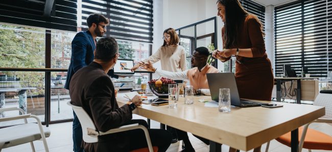 A team in a meeting room discussing sales and marketing solutions